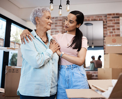A senior woman moving house with help from her daughter