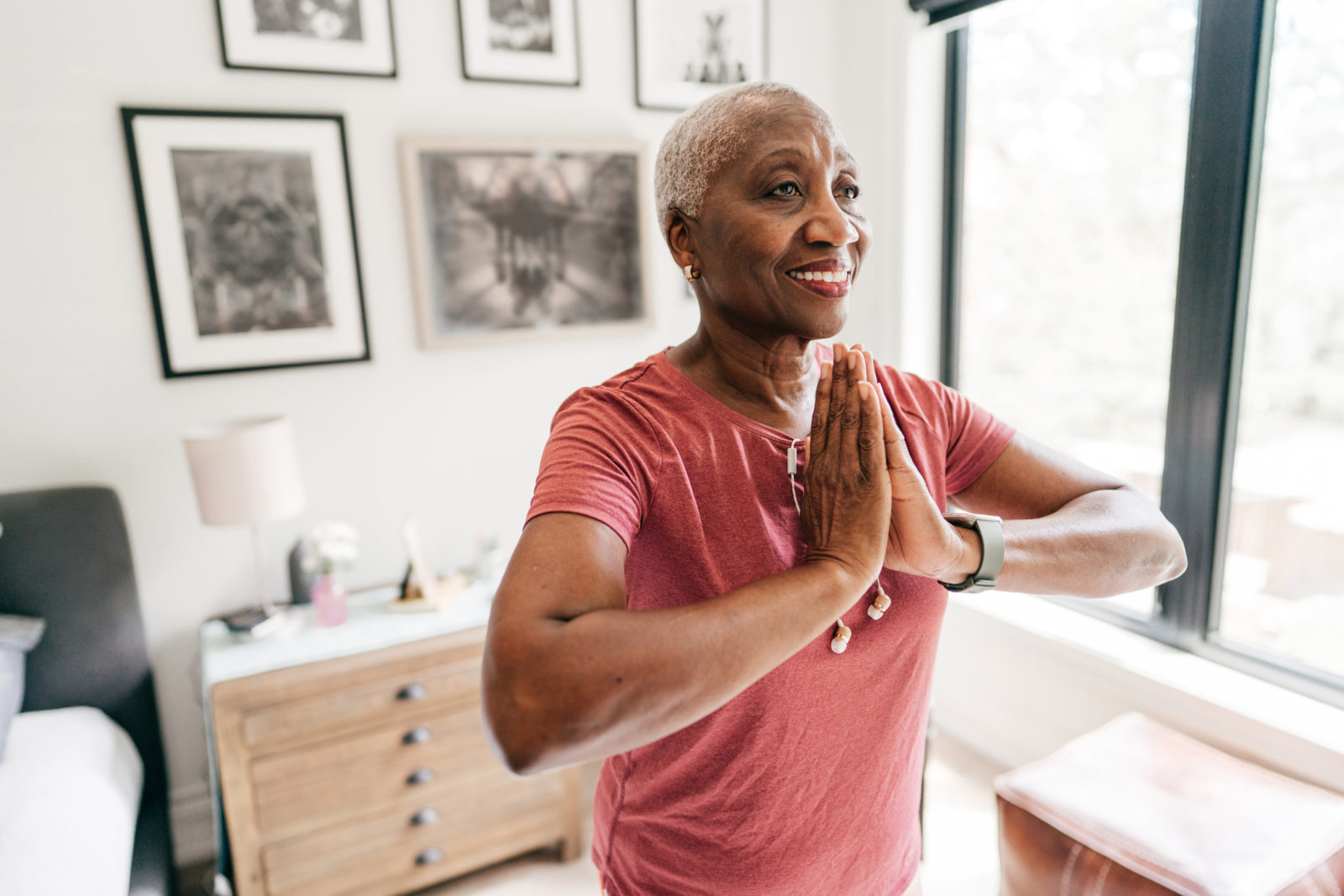 Senior women taking care of her wellbeing, she is exercising at home in sportswear